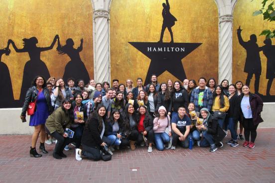 Group photo of TRIO SSS in front of Hamilton poster